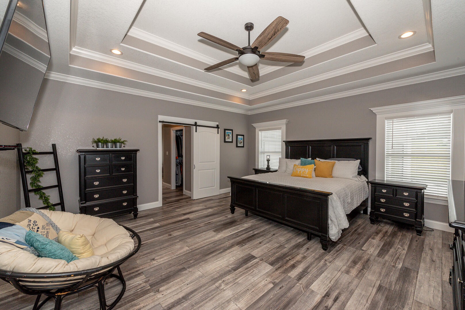 4833 Morganton Road Greenback, TN 37742 - Photo 22 of 40 a bedroom with a bed a dresser and a chandelier