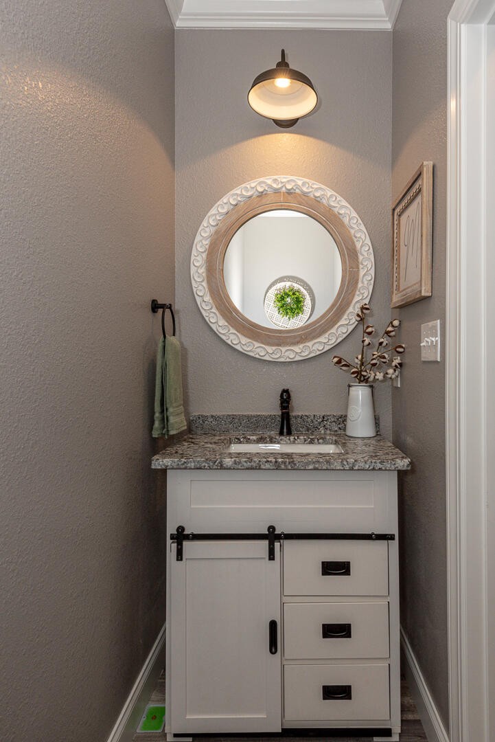4833 Morganton Road Greenback, TN 37742 - Photo 32 of 40 a bathroom with a granite countertop sink a toilet and a mirror