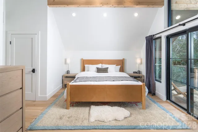 a bedroom with a bed and glass door