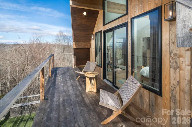a view of balcony with wooden floor and outdoor seating