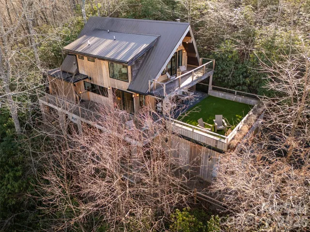 an aerial view of a house with a yard