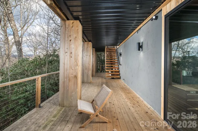 a view of a two chairs in the balcony