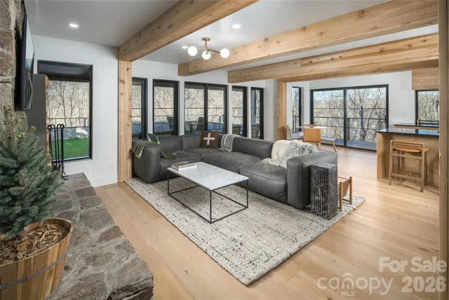 a living room with furniture rug and a table