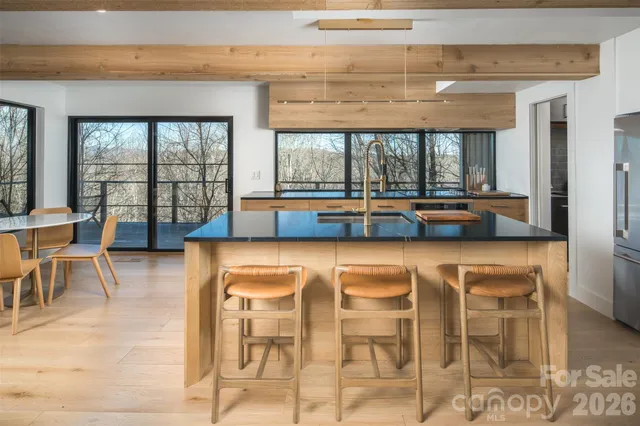 a living room with a large window and furniture