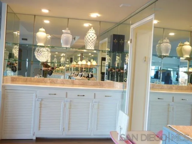 939 Coast Boulevard, Unit 6A La Jolla, CA 92037 - Photo 38 of 38 a bathroom with a sink a large mirror and shower