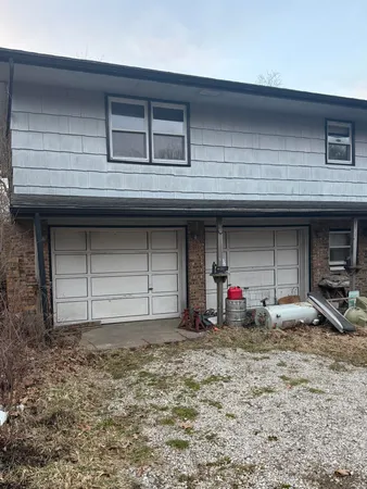 a view of a house with two windows and a table