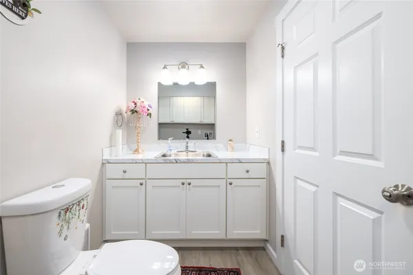 a bathroom with a toilet sink and mirror