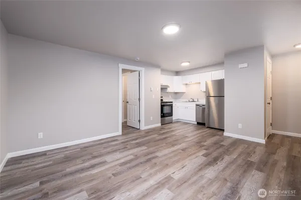 a view of a kitchen with a sink and a refrigerator