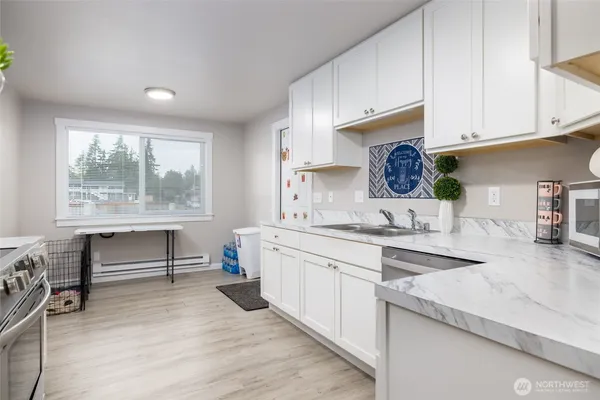 a kitchen with sink cabinets and wooden floor