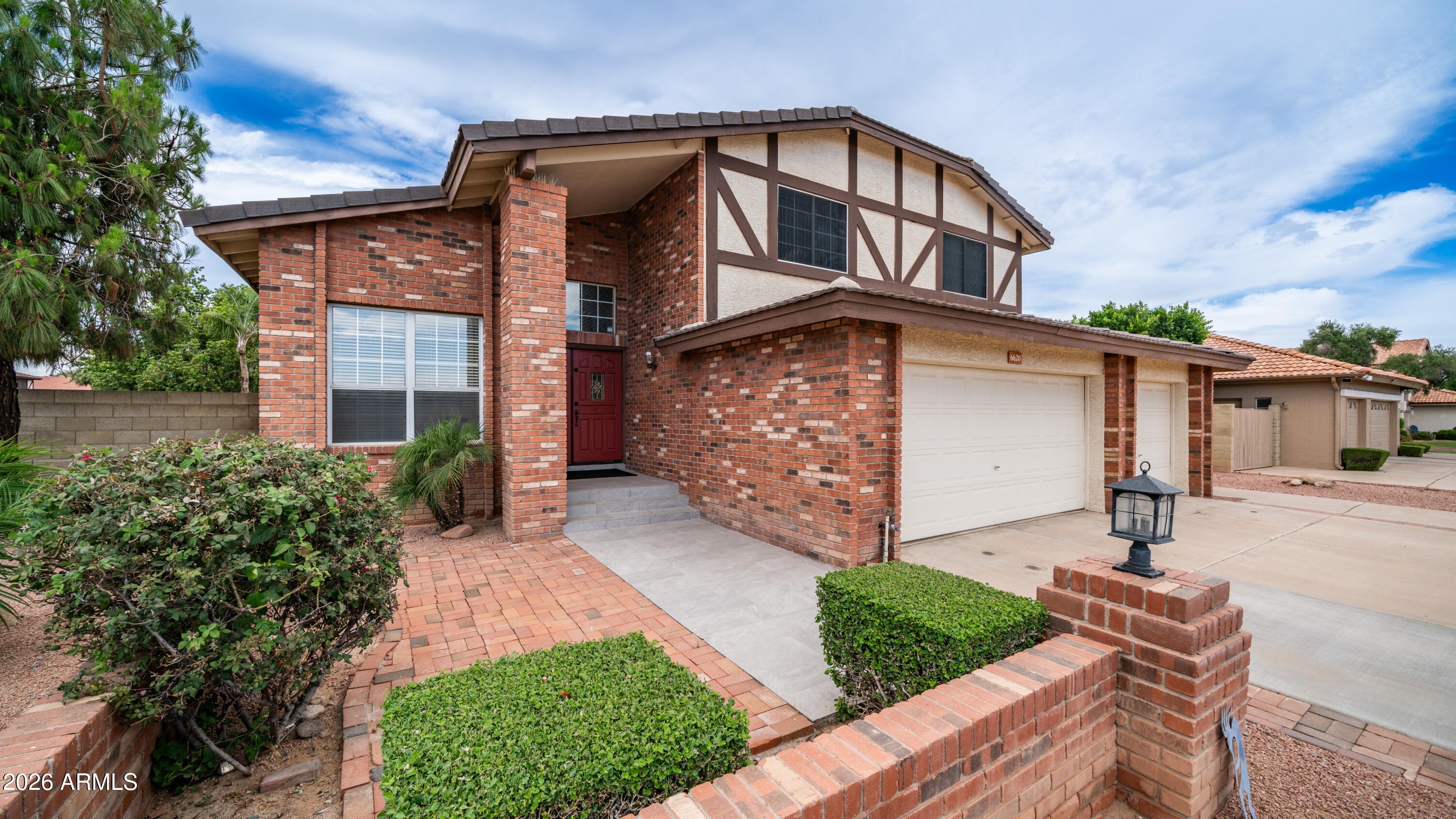 6620 West Redfield Road Glendale, AZ 85306 - Photo 2 of 33 a front view of a house with garden