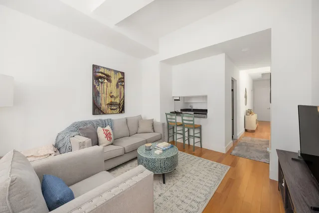a wooden bench sitting in front of building