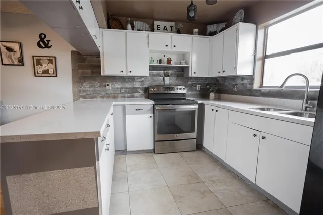 a kitchen with cabinets appliances and a sink