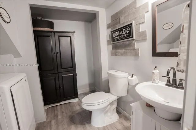 a bathroom with a toilet a sink and a mirror