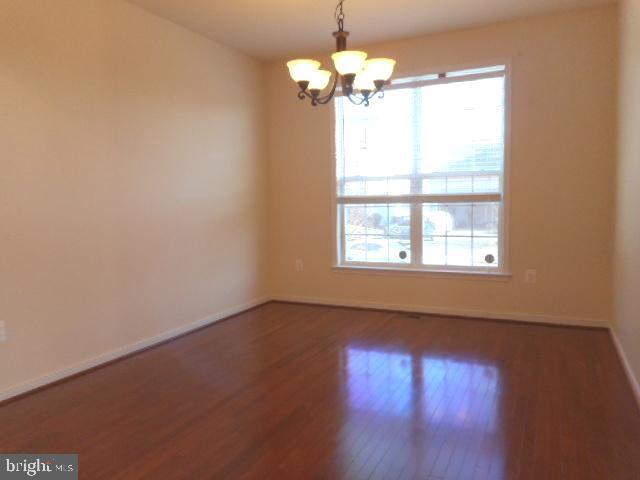 156 Standpipe Road Culpeper, VA 22701 - Photo 4 of 27 a view of an empty room with wooden floor and a window