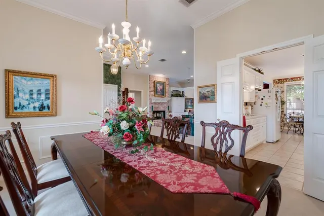 a view of a dining room with furniture and chandelier