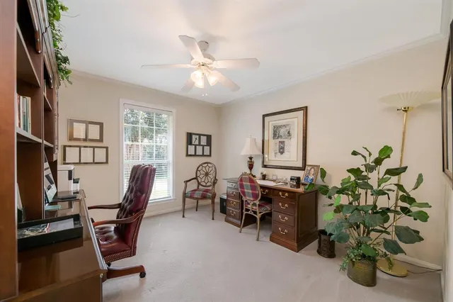 a view of a workspace with furniture and a potted plant