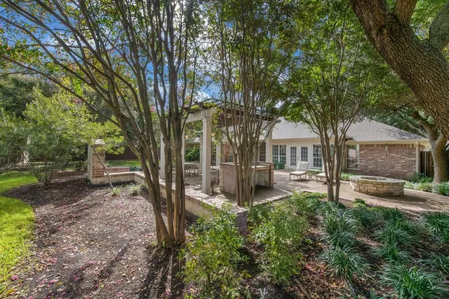 a white house that has a tree in front of it