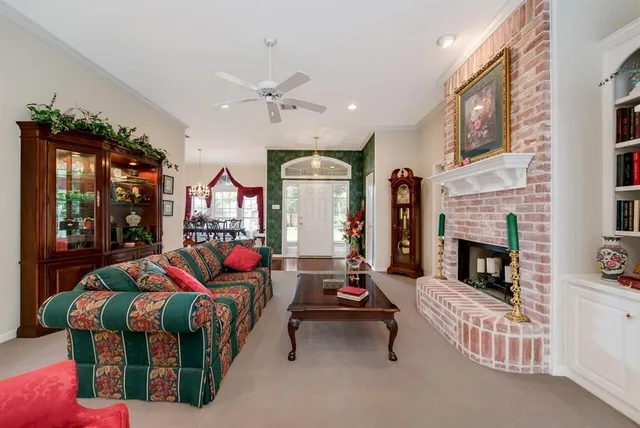 a living room with fireplace furniture and a fireplace