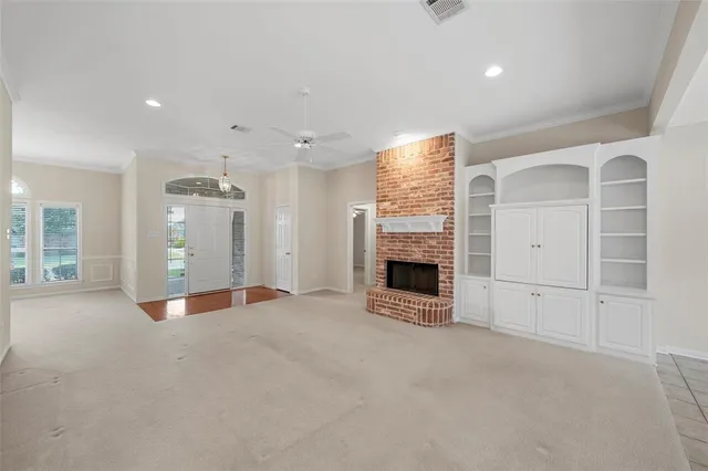 an empty room with fireplace and windows