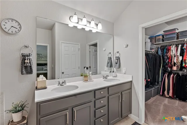a bathroom with a tub sink and mirror