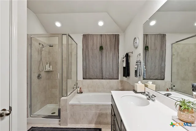 a view of a house with a yard and potted plants