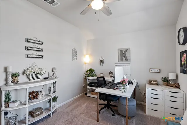 a view of a workspace with furniture