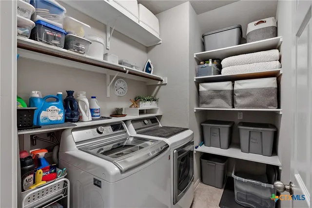 a bathroom with a sink toilet double vanity and shower
