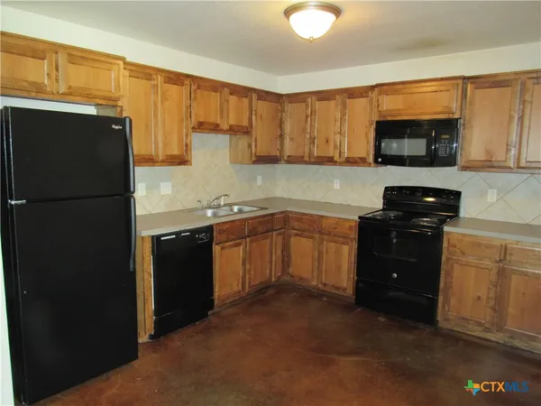 a kitchen with a sink a stove and refrigerator