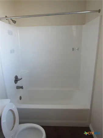 a bathroom with a bathtub and a toilet