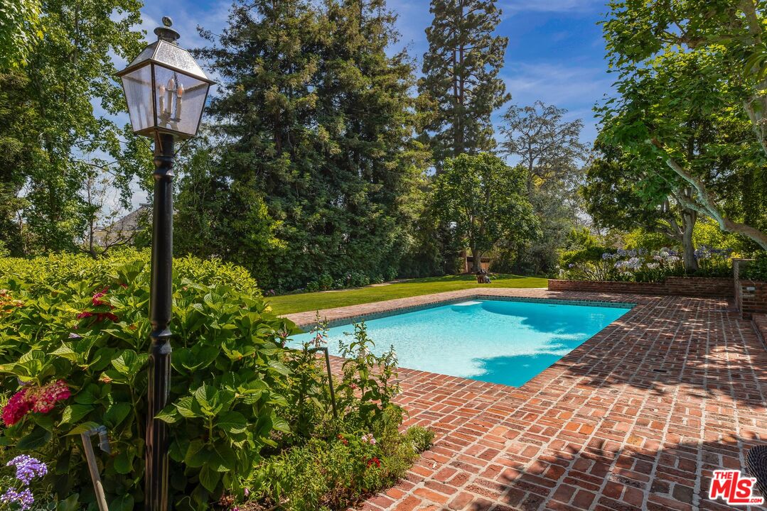 570 South Mapleton Drive Los Angeles, CA 90024 - Photo 12 of 23 a view of a swimming pool with an outdoor space and seating area