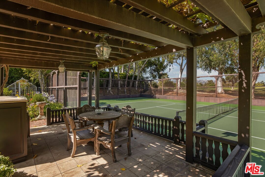 570 South Mapleton Drive Los Angeles, CA 90024 - Photo 15 of 23 a patio with glass top table and chairs