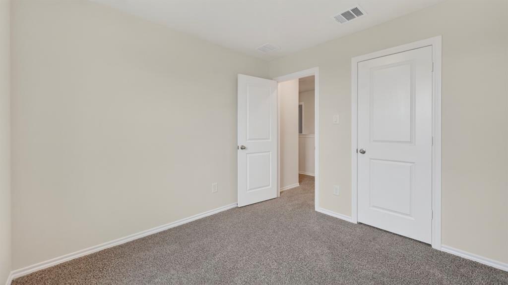 3534 Spring Time Street Forney, TX 75126 - Photo 18 of 24 Neutral gray-beige walls complement the gray carpeting
