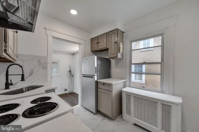 a kitchen with a refrigerator and a stove