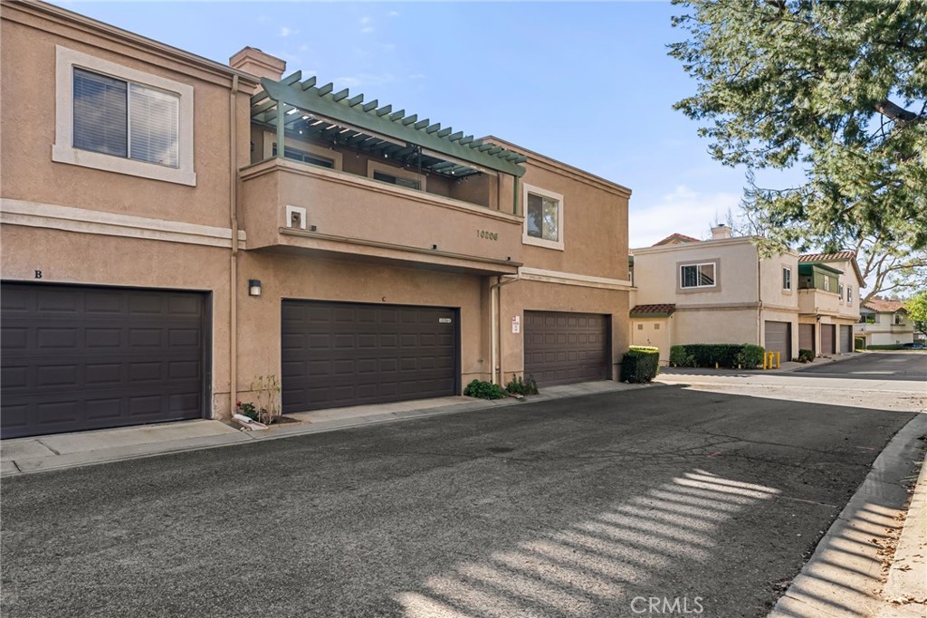 10206 Chaparral Way, Unit C Rancho Cucamonga, CA 91730 - Photo 1 of 1 a front view of a house with a garage