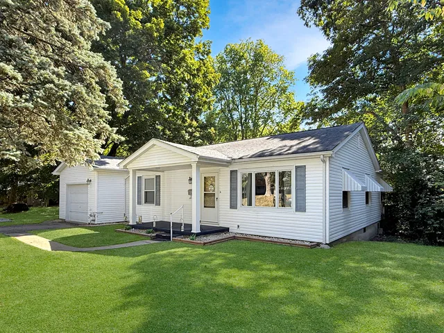 a view of a house with a backyard