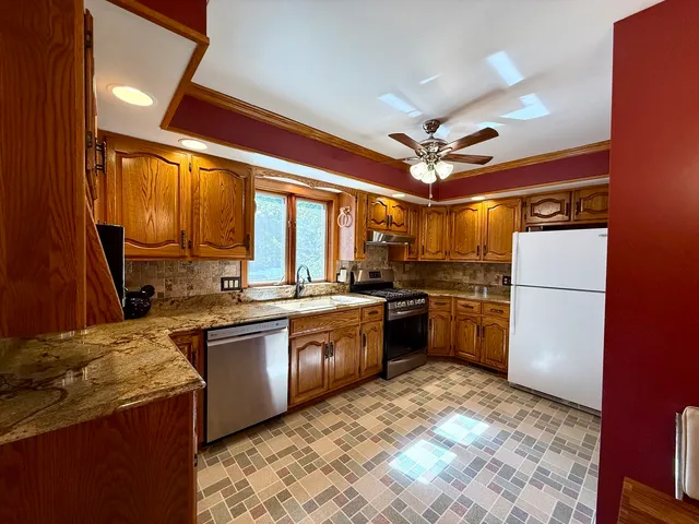 a kitchen with a stove a sink and a refrigerator