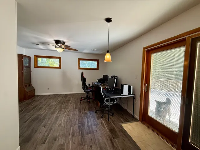 a view of a workspace with furniture and a window