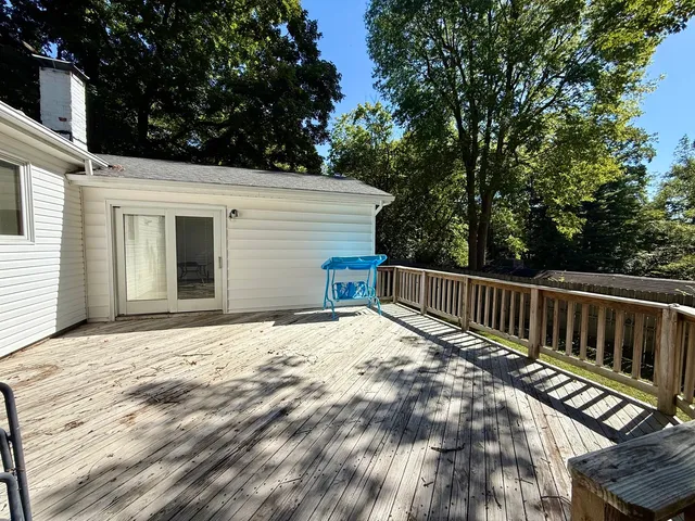a view of backyard with deck and wooden floor