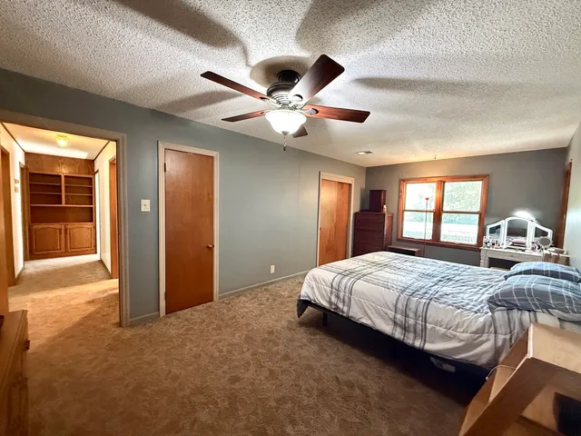 a bedroom with a large bed and a chandelier