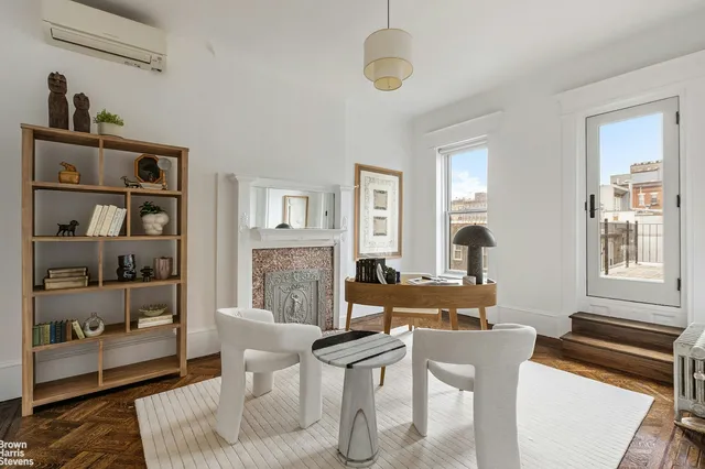 a living room with furniture a rug and a window