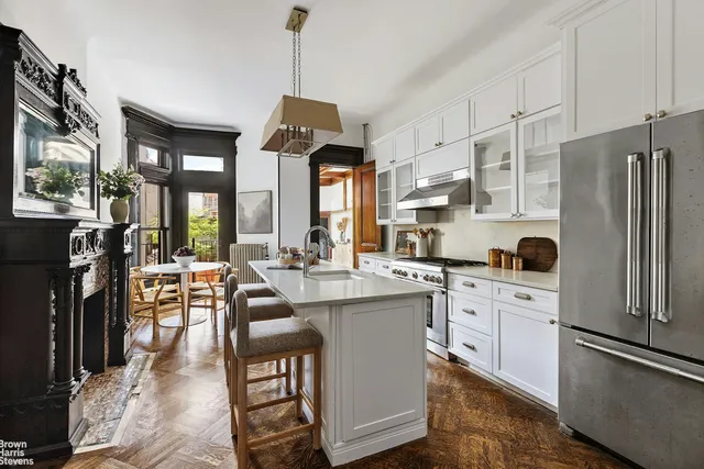 a open kitchen with stainless steel appliances granite countertop a stove refrigerator and cabinets