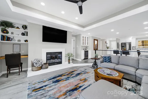 a living room with furniture a fireplace and a flat screen tv