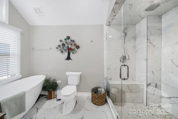 a bathroom with a toilet sink and shower