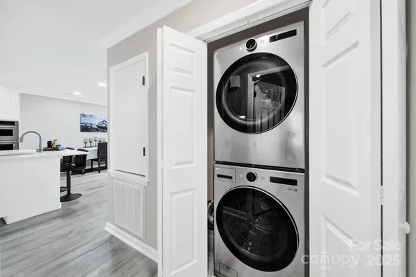 a view of a hallway with washer and dryer
