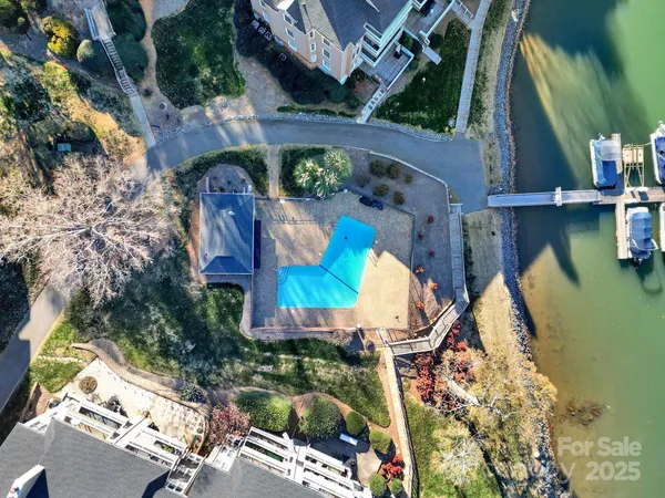 an aerial view of a house swimming pool outdoor seating and yard