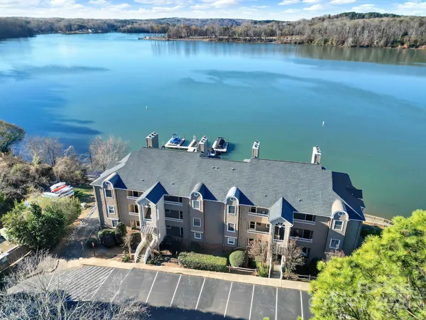 an aerial view of a house with a lake view