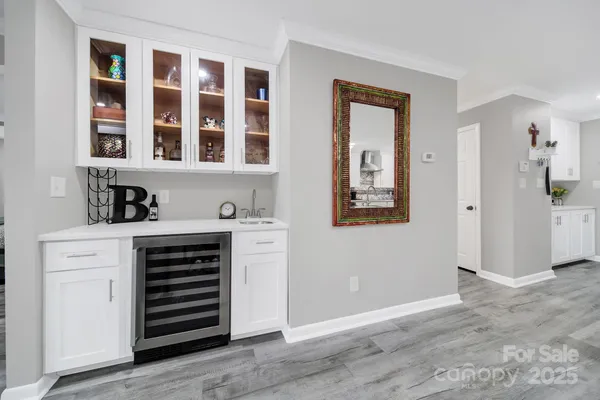 a view of an entryway with wooden floor and cabinet