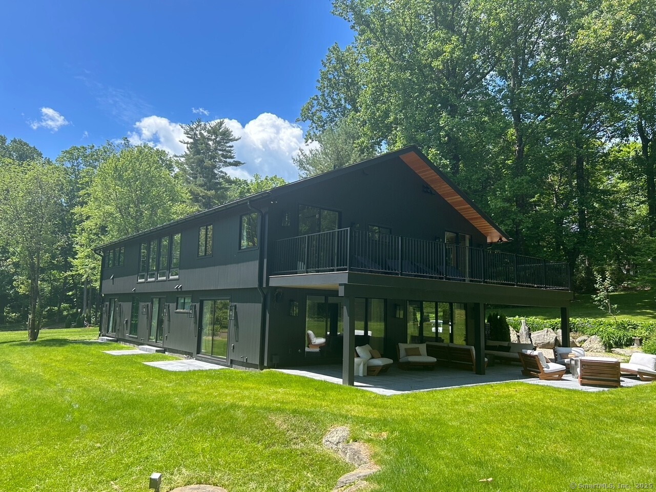a front view of a house with a yard table and chairs