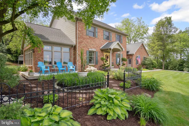 a front view of a house with a yard and potted plants