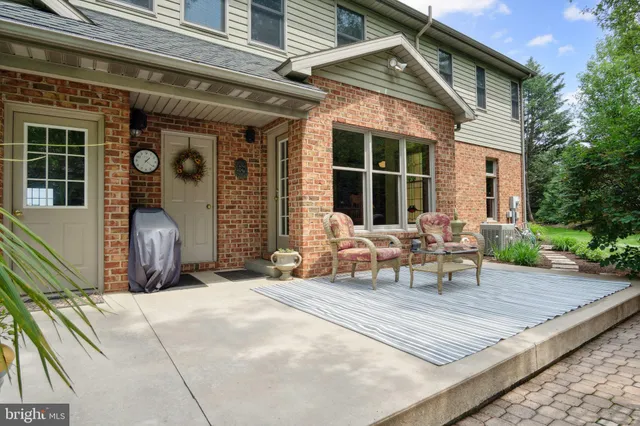 a living room with furniture a fireplace and a large window